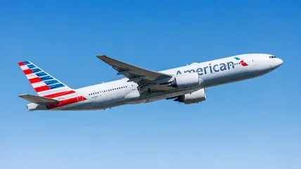 An American Airlines Boeing 777 taking off from an airport