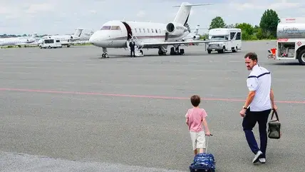 Passengers walk to a private jet a Teterboro Airport