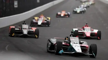 Cars racing at the Indy 500 in 2025, seen on track.